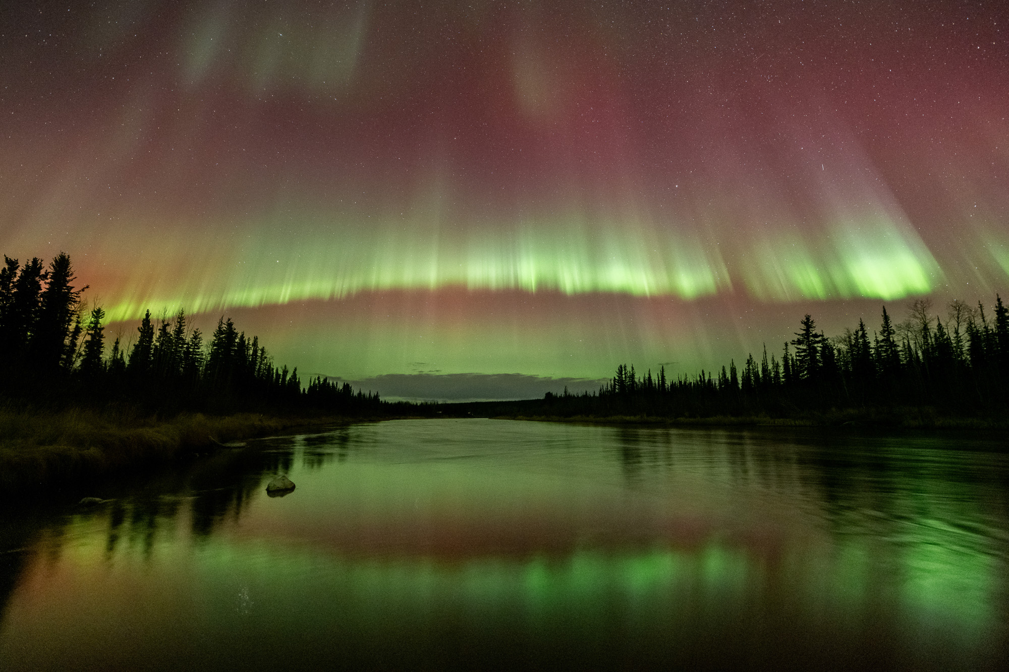Aurora reflecting on a river in Alaska