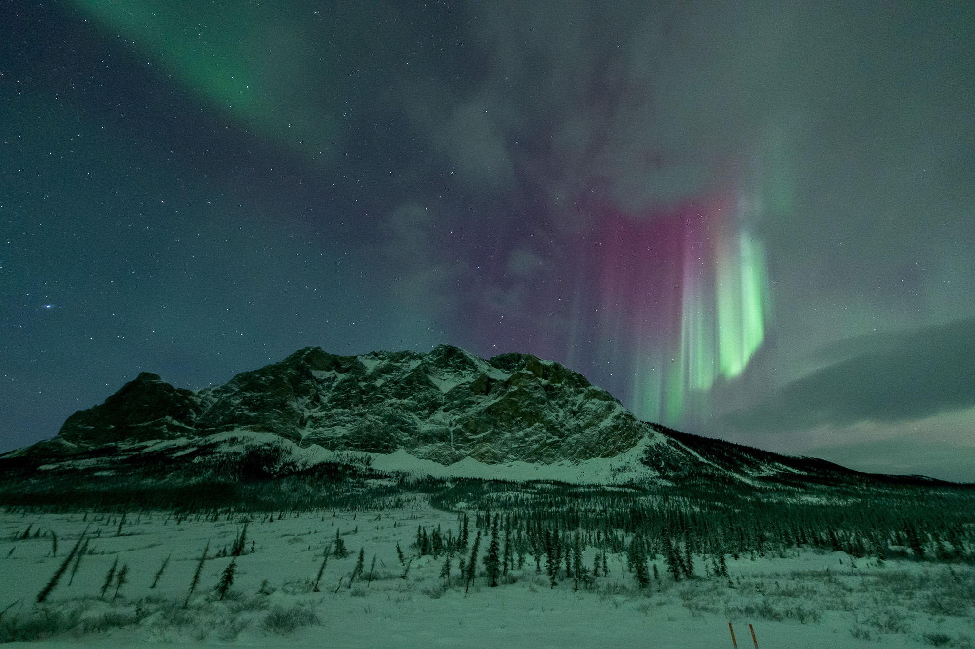 Aurora curtains above Sukakpak Mountain in Alaska