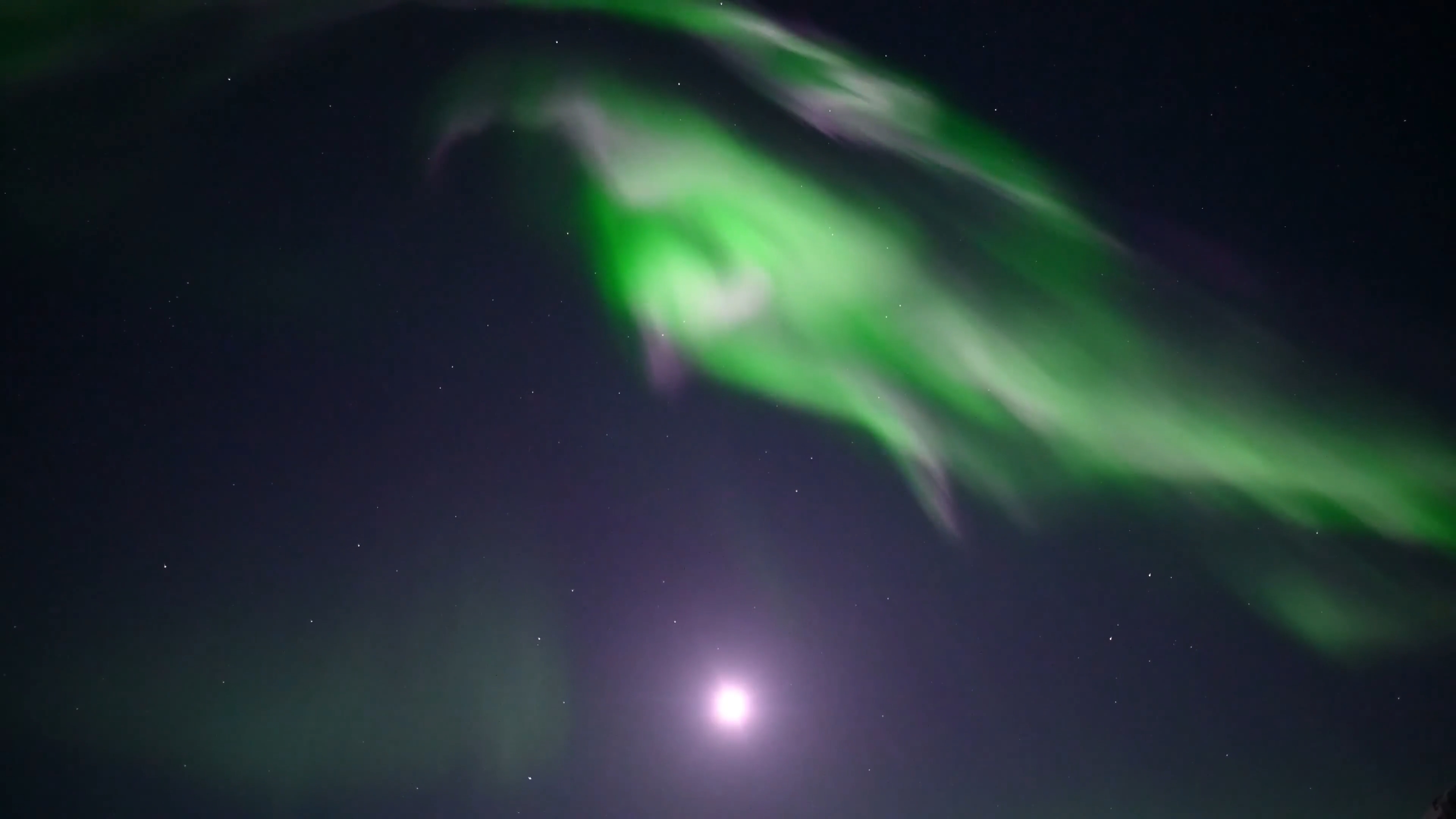 Real time video of aurora borealis overhead corona under moonlight at Atigun Pass, Dalton Highway, Alaska.